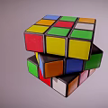 Three Stacked Rubiks Cubes With Colorful Square Faces And Various Colors