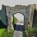 Ancient Stone Arch Ruins In Countryside With Green Grass And Pathway