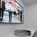Television Screen Displaying Variety Show With People And Projector With Purple Light Beam