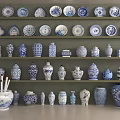 Blue and White Ceramic Vessels with Traditional Patterns Displayed on Shelves
