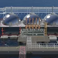Aerial View of Large Ship at Port With White Spherical Tanks and Industrial Structures