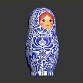 Traditional Matryoshka Doll With Blue White Floral Patterns And Red Hair