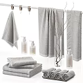 Gray Towels Arrangement In Bathroom With Toiletries And Decorative Items