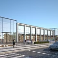 Modern Commercial Street With Glass Curtain Wall Storefronts Walking Pedestrians Parked Cars And Street Greenery