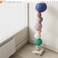 Artistic Colorful Spheres Stacked Sculpture In Indoor Corner With Window Radiator Background