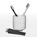 Stylish Bathroom Accessories Set With White Speckled Cup Black Gray Toothbrushes And Black Toothpaste Tube
