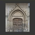 Historic Architecture Featuring Arched Stone Doorway With Intricate Carvings And Wooden Paneled Door