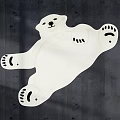 Polar Bear Shaped White Rug With Black Paw Details On Dark Wooden Floor