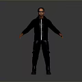 Man Wearing Sunglasses In Black Jacket And Pants Standing With Arms Outstretched Against Gray Background