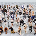 Group Of Diverse People Standing And Sitting In Various Poses On Light Floor