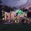 Outdoor Celebration Setup With WE LOVE YOU MOM Sign String Lights Greenery Canopy On Grass