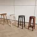 Modern Interior Featuring Four Different Wooden Bar Stools With Light Wall And Herringbone Floor