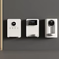 Three White Wall Mounted Household Electrical Appliances With Control Panels And Displays