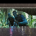 Tropical Rainforest Themed Waterfall Feature Wall With Human Silhouettes And Water Reflection