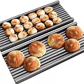 Fresh Round Bread Loaves on Metal Baking Grills with Golden Brown Crusts
