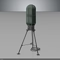 Green Cylindrical Equipment with Metal Tripod Base and Cable Nearby