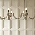 Modern Unique Design Chandeliers Featuring Multiple Lights Hanging On White Paneled Wall
