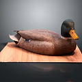 Brown Duck with Yellow Beak and Black Head on Wooden Board against Gray Background
