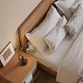 Cozy Bedroom Interior With Double Bed Wooden Headboard Framed Art Patterned Bedding And Curtains