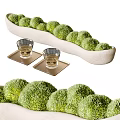 Green Round Bonsai Potted Plants in White Long Container with Glass Cups on Coasters