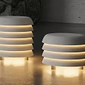 Illuminated Cylindrical Striped Floor Lamps In Modern Indoor Space With Stone Walls