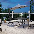 Scenic Wooden Deck Patio With White Railings Dining Table Umbrella Flowers And Twilight Sky