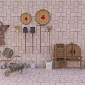 Traditional Industrial Equipment Display With Stone Mill Wheelbarrow And Hanging Tools On Brick Wall