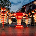 Illuminated Red Lanterns Art Installation With Traditional Pavilion And Architecture In Nighttime Courtyard