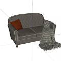 Dark Leather Double Sofa With Tufted Design Orange Pillow And Striped Blanket