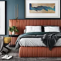 Modern Double Bed with Orange Leather Headboard Deep Blue Wall Art and Gold Sconces