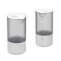 Two Modern Cylindrical Humidifiers With Transparent Water Tank And Control Buttons