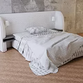 White Quilted Headboard Double Bed With Bedside Lamps Gray Bedding And Wooden Floor