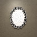 Oval Mirror With Floral Accents Reflecting Room Interior With Sofa And Carpet Against Brown Wall