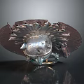 Character And Creature Sculpture With Silver Metallic Body And Radiant Ornamental Details On Dark Surface