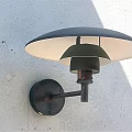 Modern Wall Lamp With Black Bracket Round Light Brown Lampshade Mounted On Gray Textured Wall