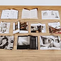 Open Books Featuring Black And White Photos Text And Architectural Images On Wooden Floor