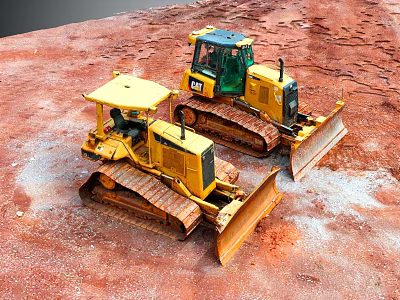 Yellow Bulldozers With Tracks And Blades Working On Red Construction Ground 3d model
