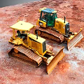 Yellow Bulldozers With Tracks And Blades Working On Red Construction Ground