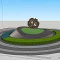 Golden Twisted Sculpture On Circular Lawn With Paved Area And Colorful Autumn Trees