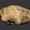 Yellow Stone Sculpture With Intricate Carved Characters And Text Details