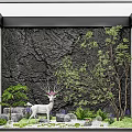 Indoor Landscape with Textured Black Wall White Deer Statue Green Plants Stones and White Pebbles