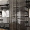 Modern Wardrobe Interior With Black Glass Partitions Hanging White Shirts And Storage Shelves
