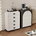 Modern White and Black Chest of Drawers with Decorative Items on Top in Room Interior