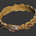 Golden Bracelet With Intricate Carved Design And Decorative White Accents