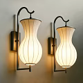 Two Modern Wall Sconces With White Fabric Shades Black Metal Brackets And Warm Lighting