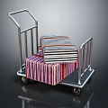 Metal Cart With Red Blue White Striped Packages And Wheels On Dark Background