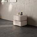 Modern Minimalist Bedside Table With Round Clock And Small Black Sculpture Against Light Colored Wall