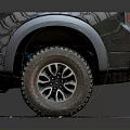 Black Pickup Truck Rear View With Large Off-Road Tires Silver Fender Flares On Brick Pavement