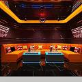 Modern KTV Lounge Interior With Orange Sofas Illuminated Coffee Tables And Large Screen TV