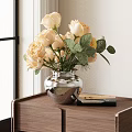 Metallic Silver Vase With Pale Yellow Roses And Green Leaves On Wooden Table With Books